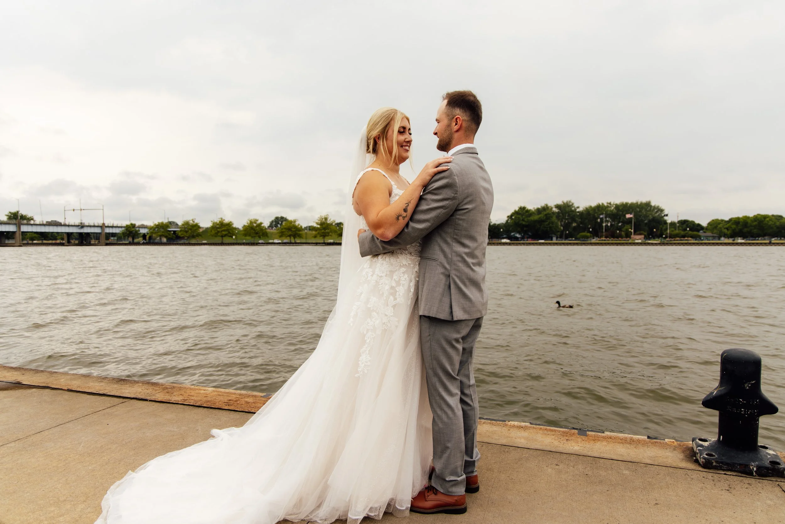 Noah and Jenna together beside the water on their wedding day in Bay City, Michigan