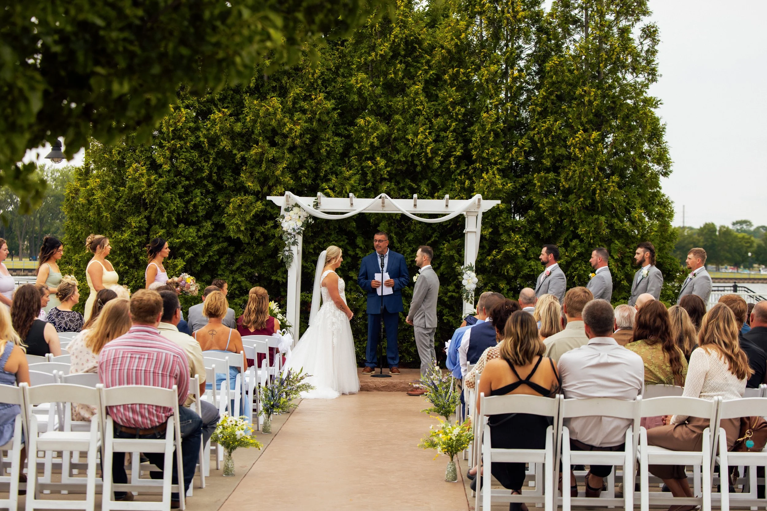 Wide view of Noah and Jenna's outdoor wedding ceremony and guests