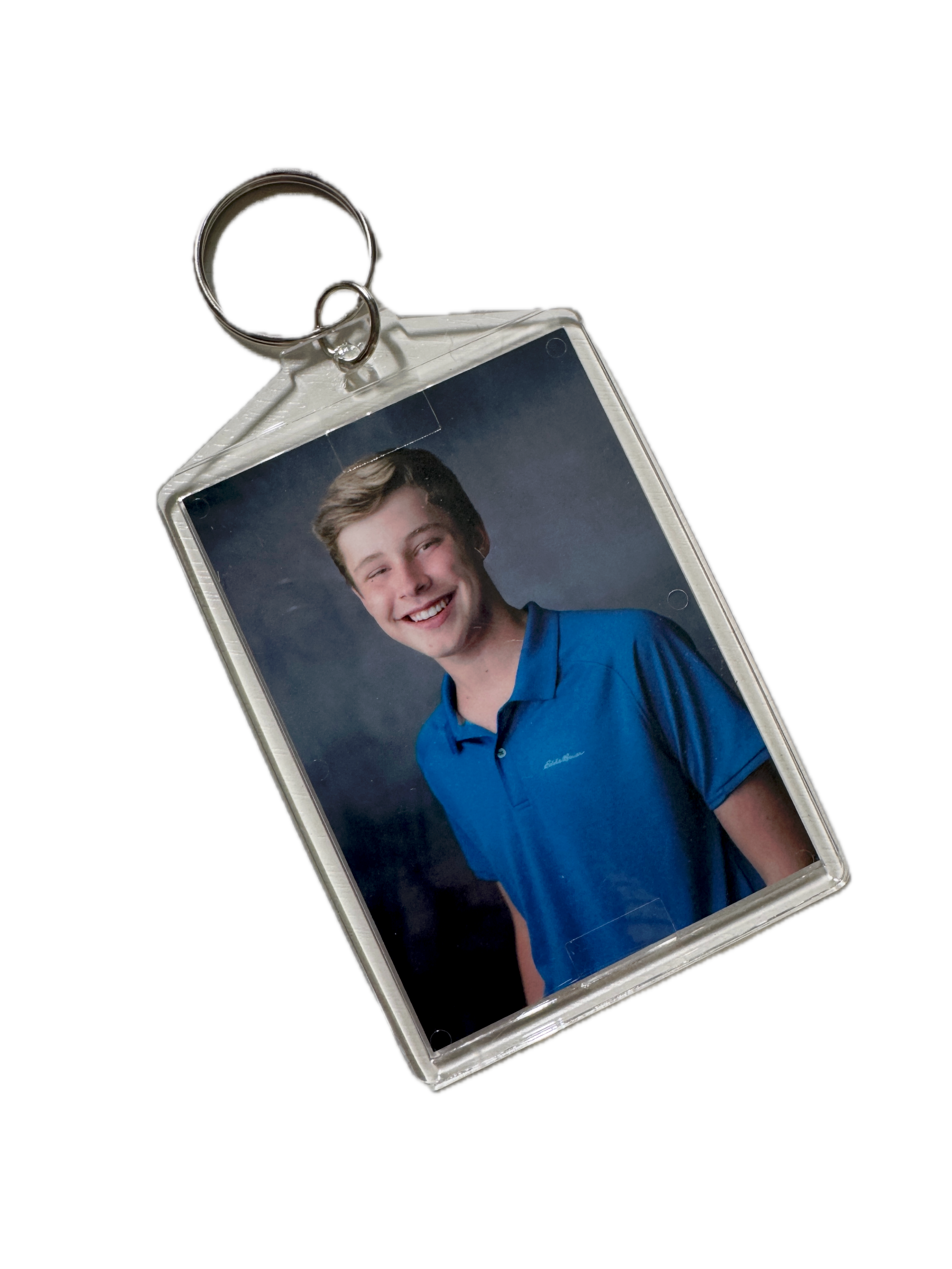 Photo keychain with a student portrait.
