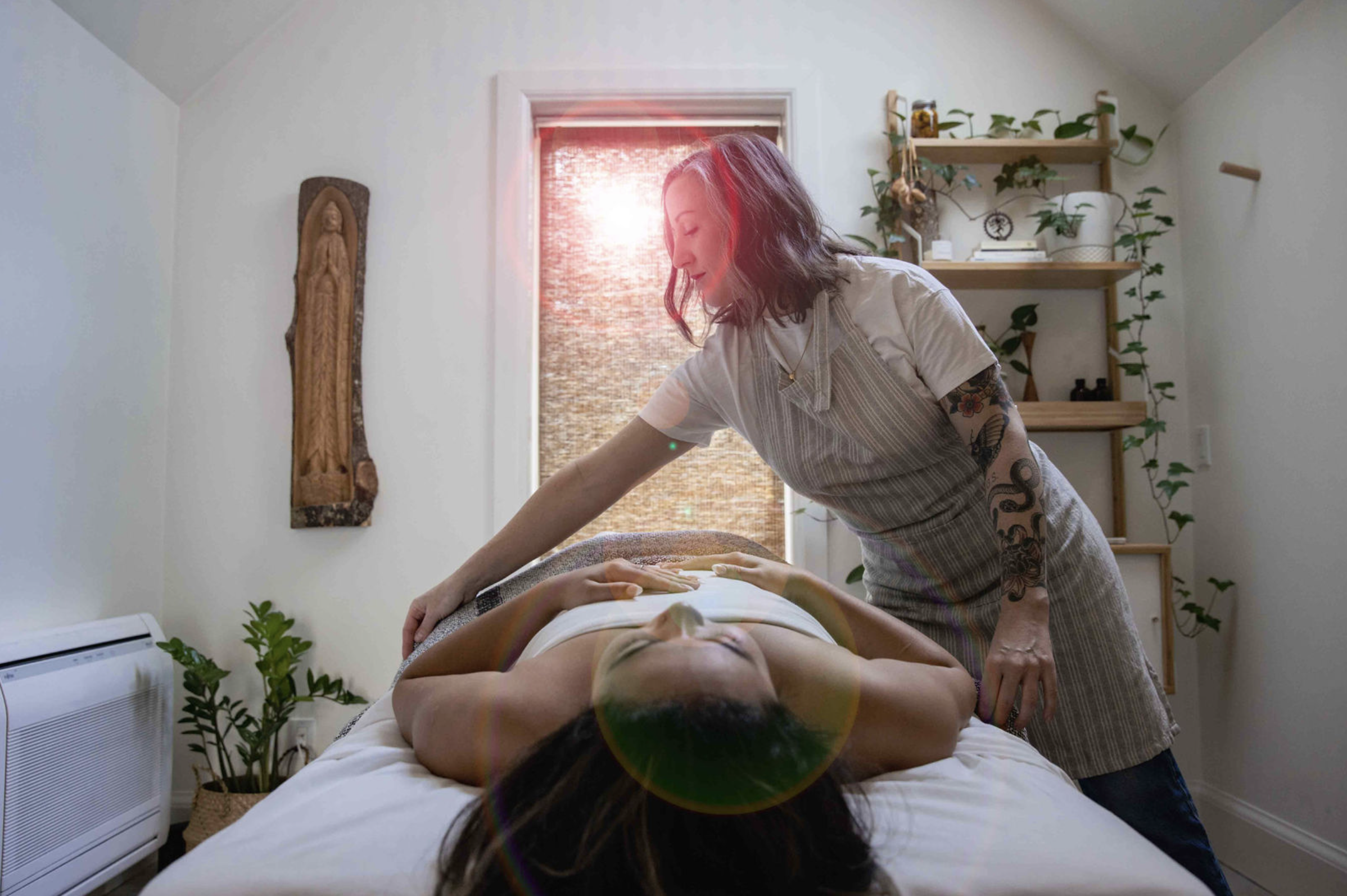 Lauren providing massage therapy in her studio