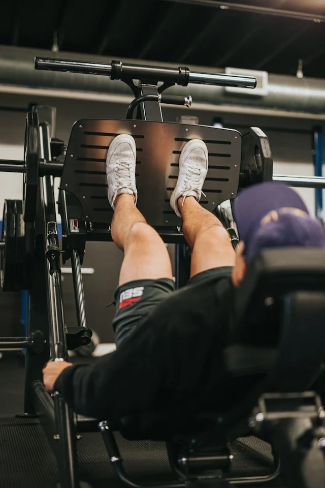 Adult builds leg strength on exercise equipment