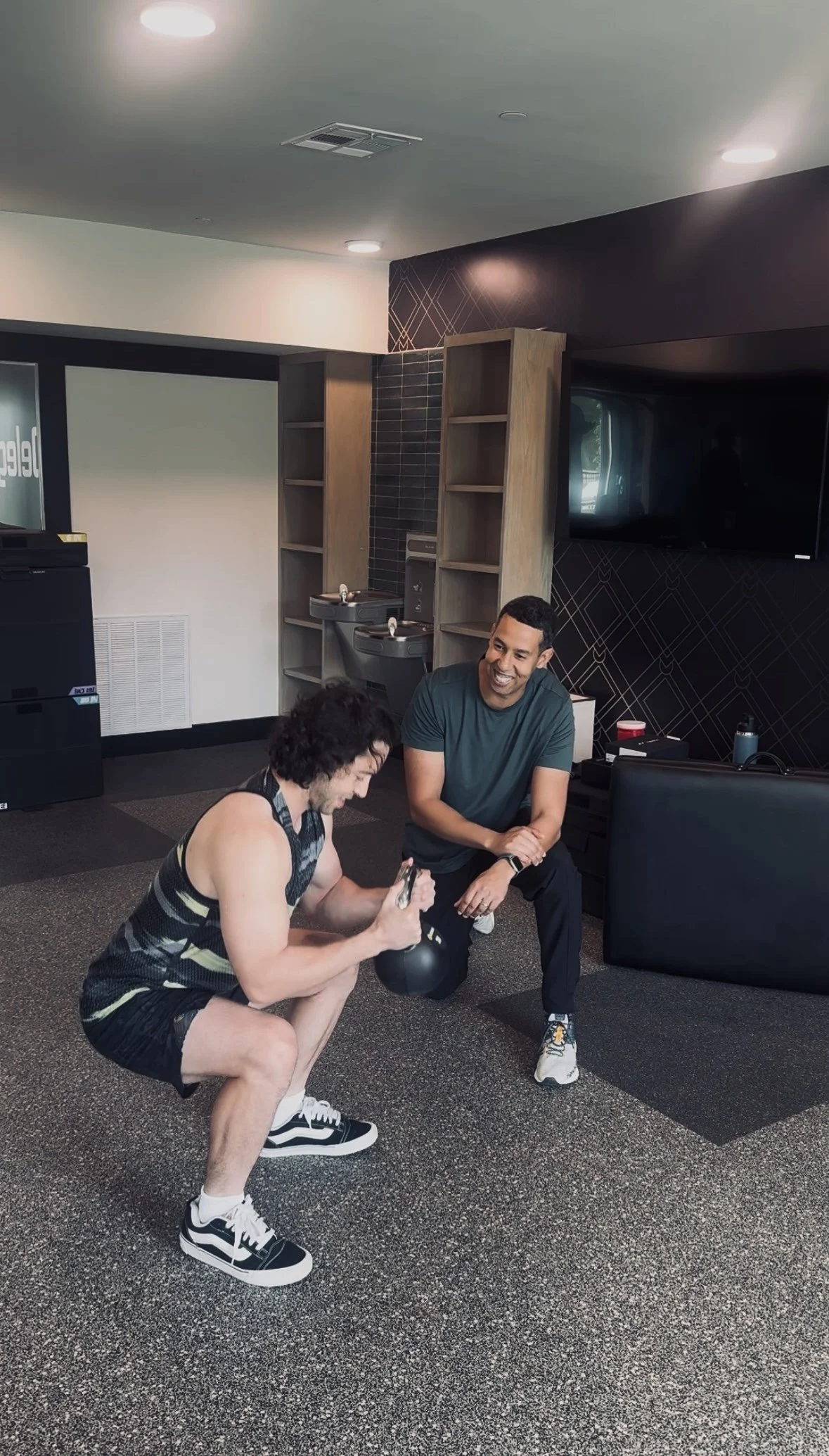 Zakaria Nadif coaching a client through a loaded squat during a one-on-one visit.