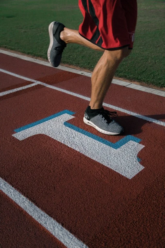 Runner stretches the calf before activity, illustrating one part of a heel-pain plan