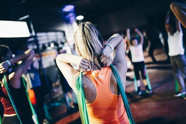 Woman practices a shoulder movement with a resistance band
