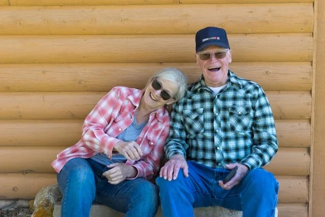 Older couple smiles together outdoors