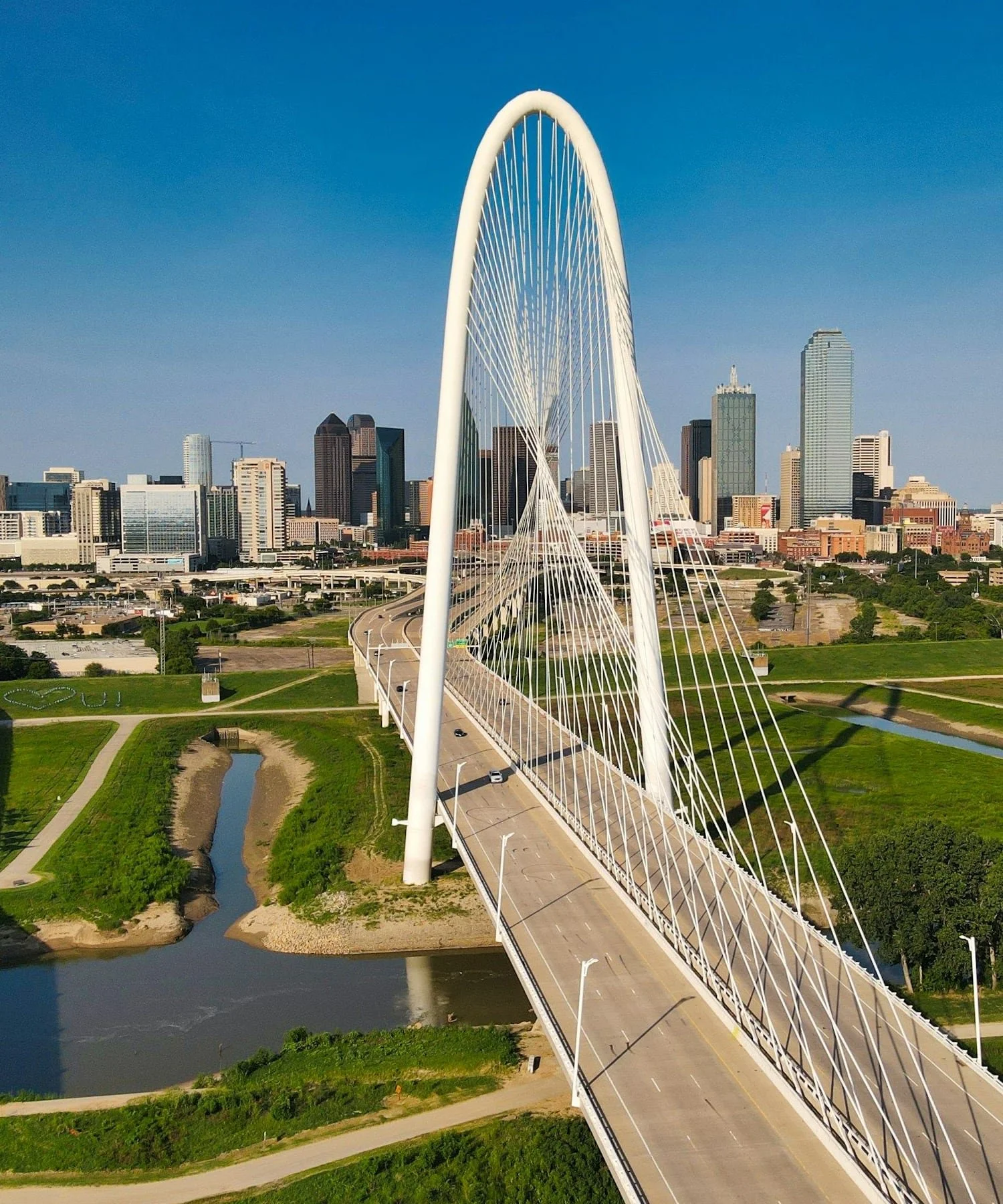 Margaret Hunt Hill Bridge with the Dallas skyline beyond it.