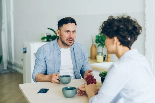 Clinician listens to a patient during a seated consultation about a stalled plan
