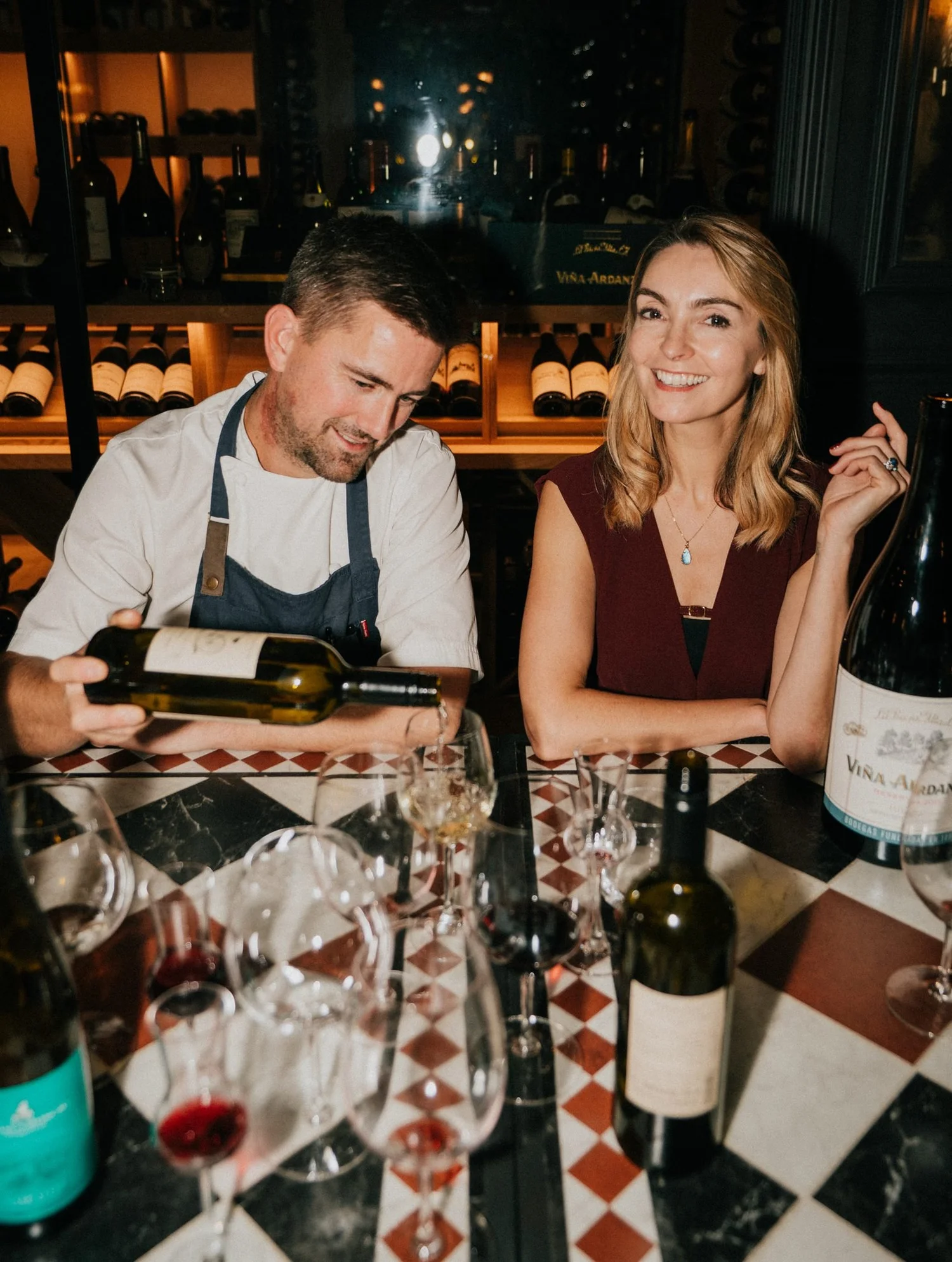 Chef Robert Thompson MBE pouring wine at the cellar counter
