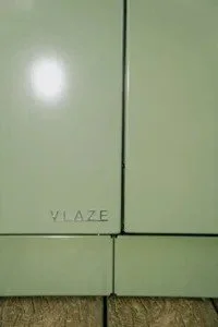 Close detail of the Vlaze name on the enamelled sage green panel