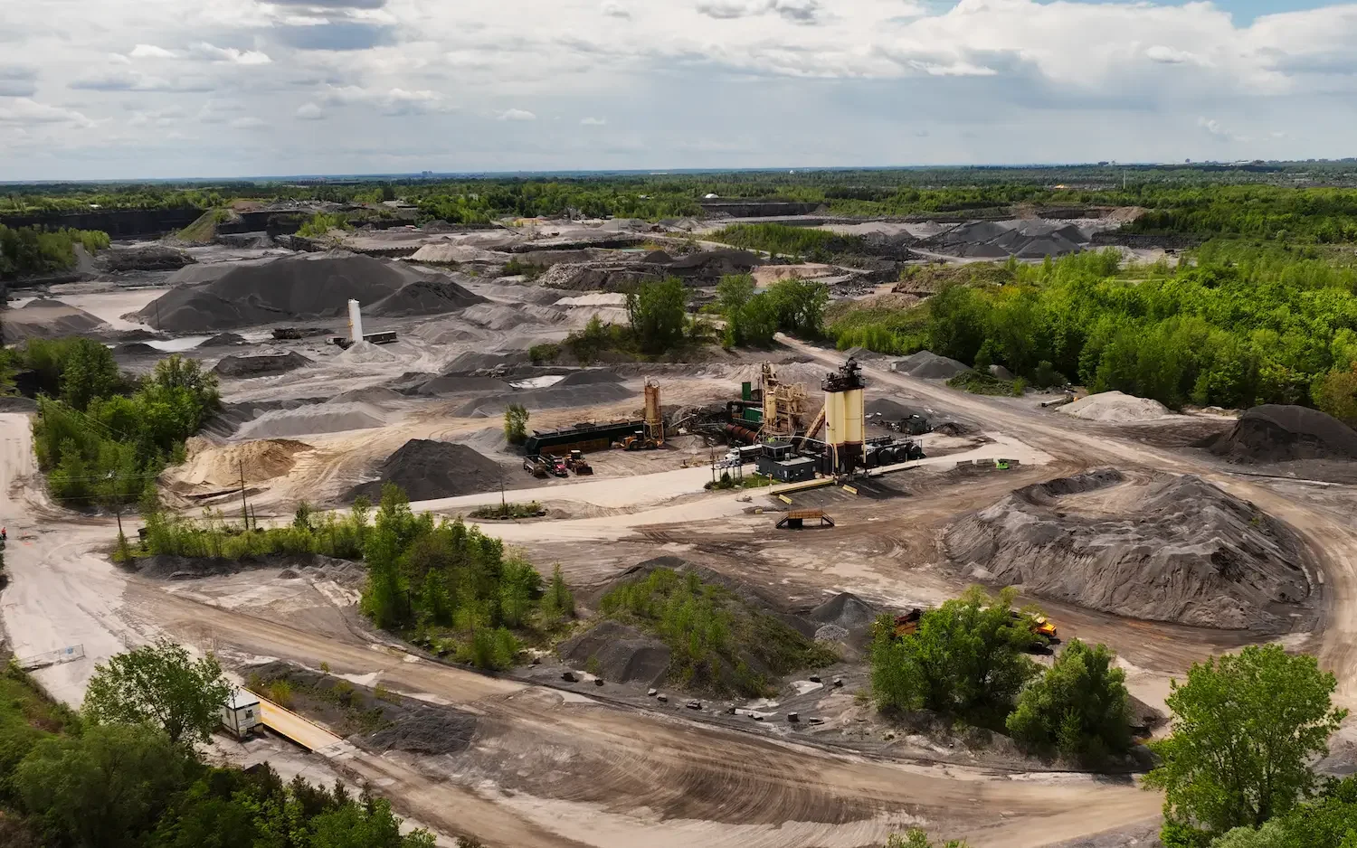 Aerial drone view of aggregate stockpiles at quarry site
