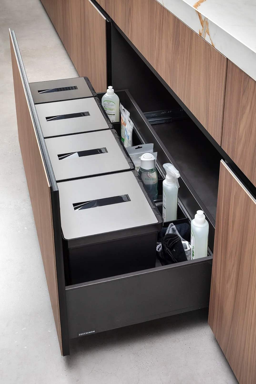 Pull-out recycling bins in a utility room by the back door.