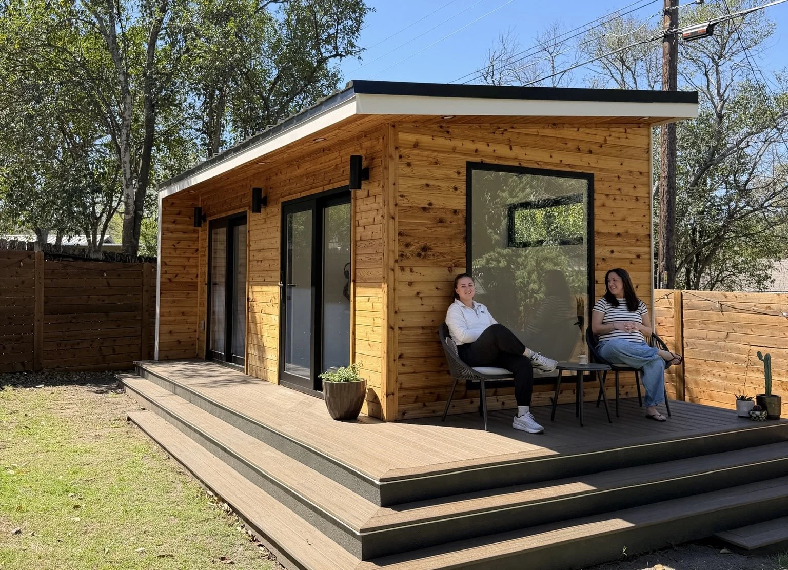 Backyard office pod exterior with sliding glass doors and composite deck