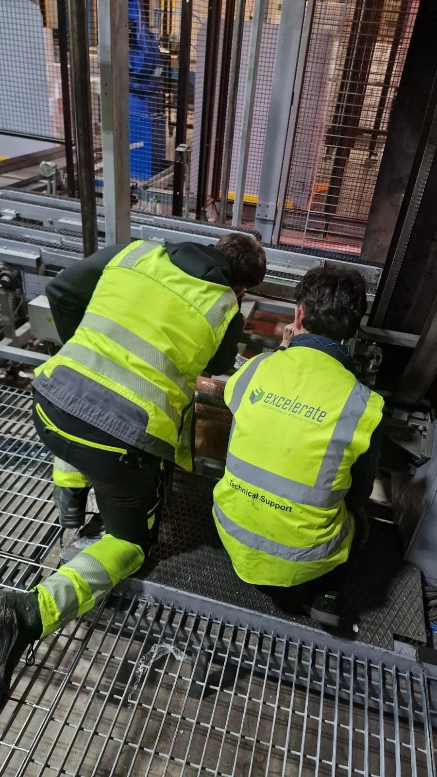 Excelerate engineers working on industrial fully automatic spiral pallet wrapper