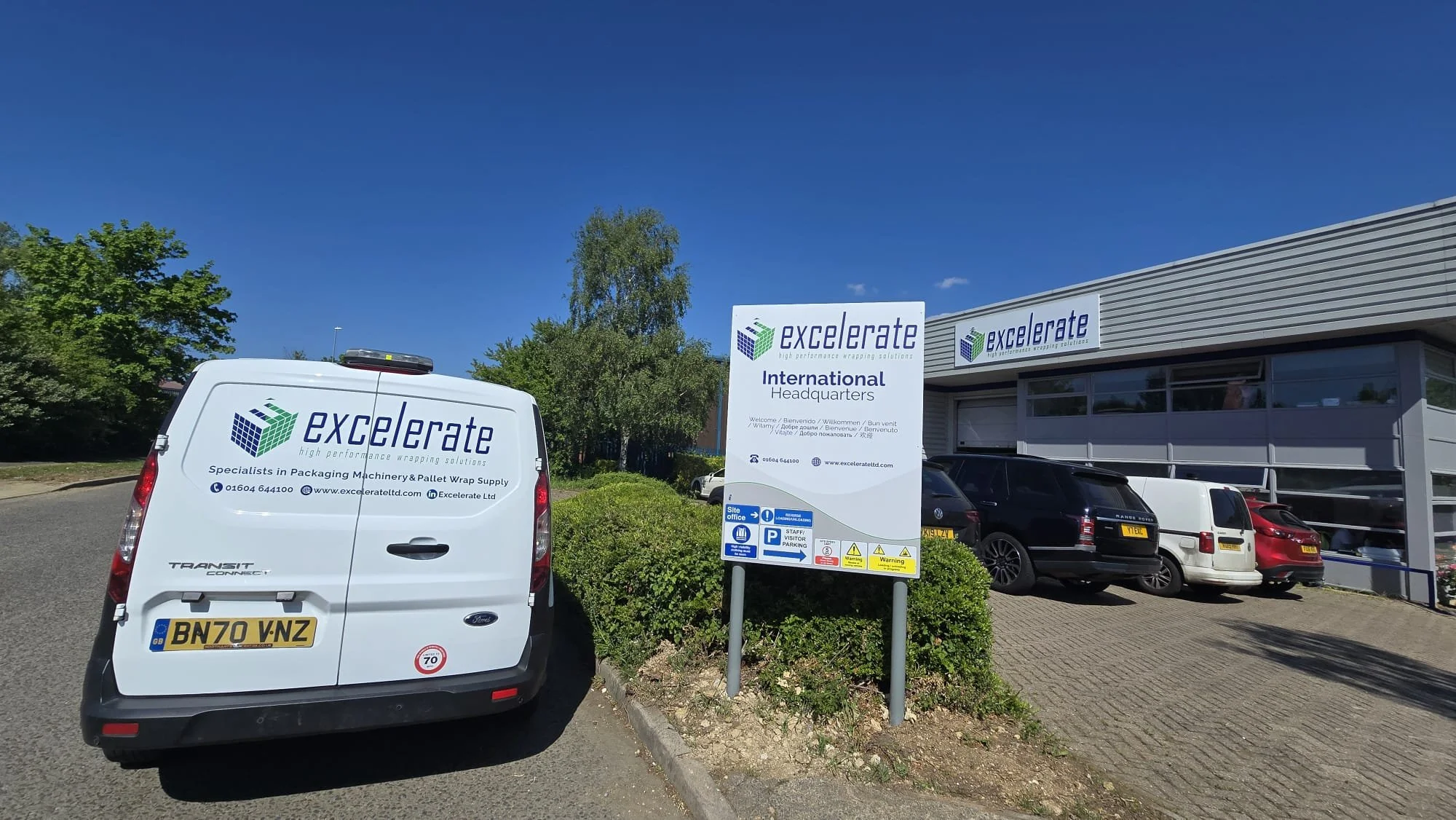 Excelerate branded service van fleet outside UK headquarters