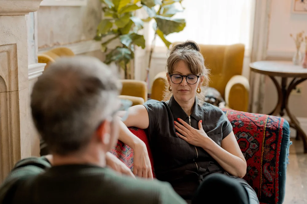 Katie Friedman with eyes closed and a hand on her chest during a regulation practice in Module 2