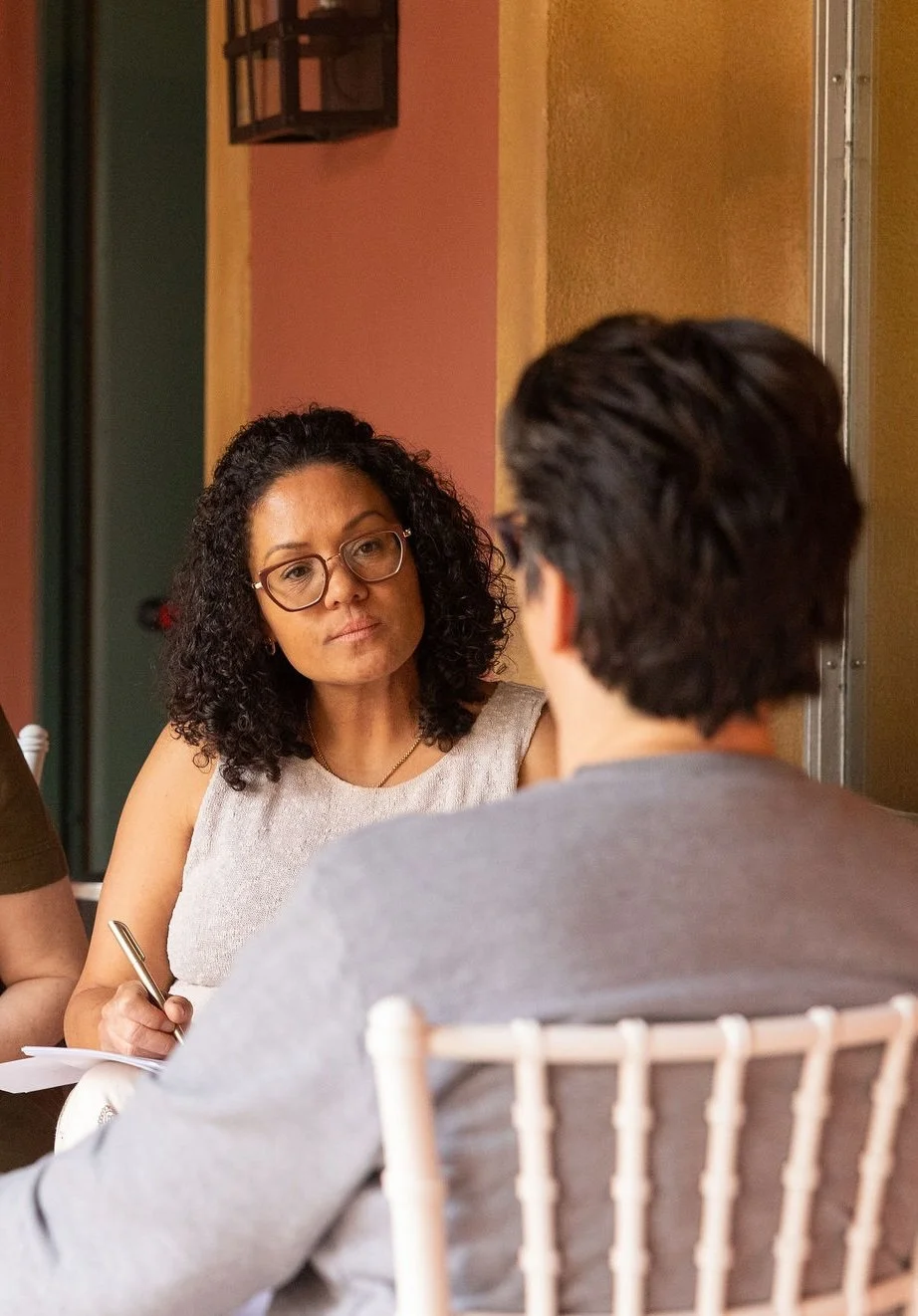 A participant listening and taking notes during an Intro to ADHD Coaching session