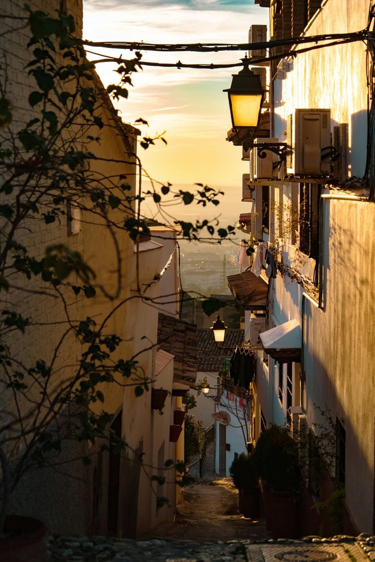 A narrow street in Granada's old town at dusk