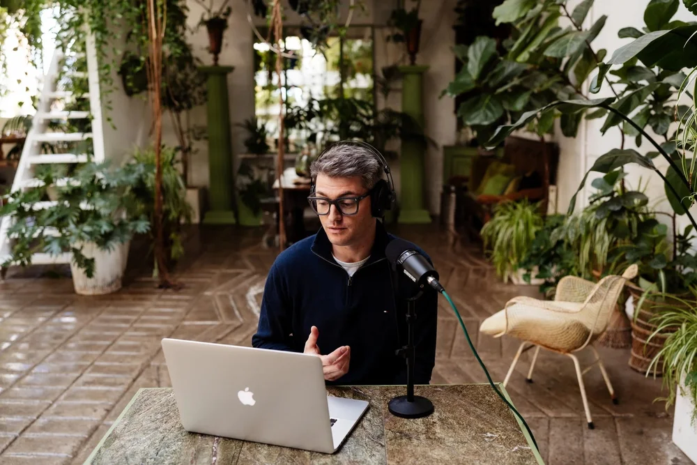 Alex Campbell, co-founder of Gold Mind Academy, mid-session at a laptop and microphone