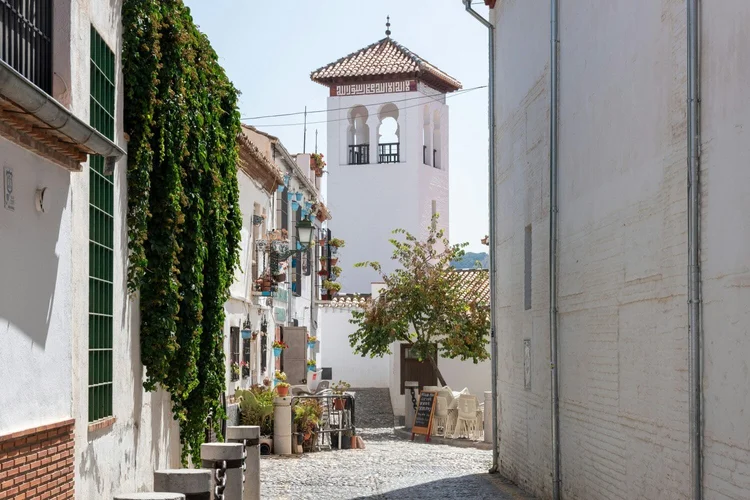 A whitewashed street and bell tower in Granada