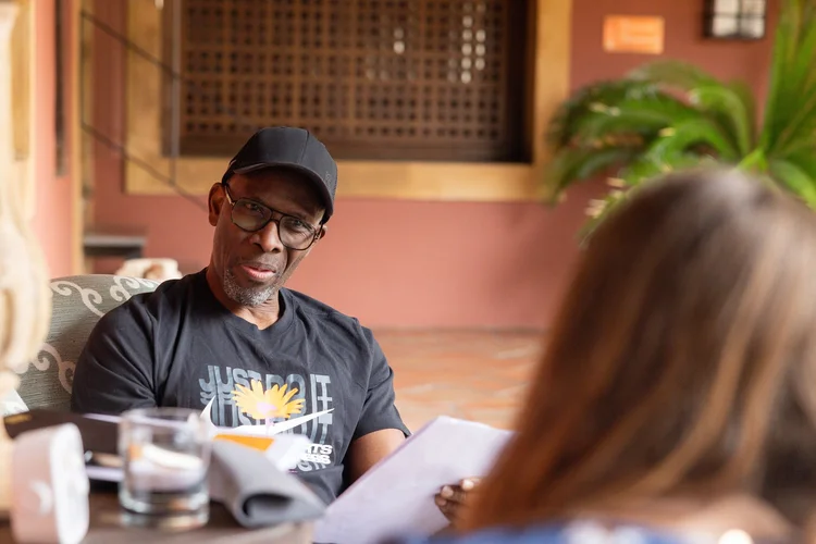 A trainee coach speaking during a group session