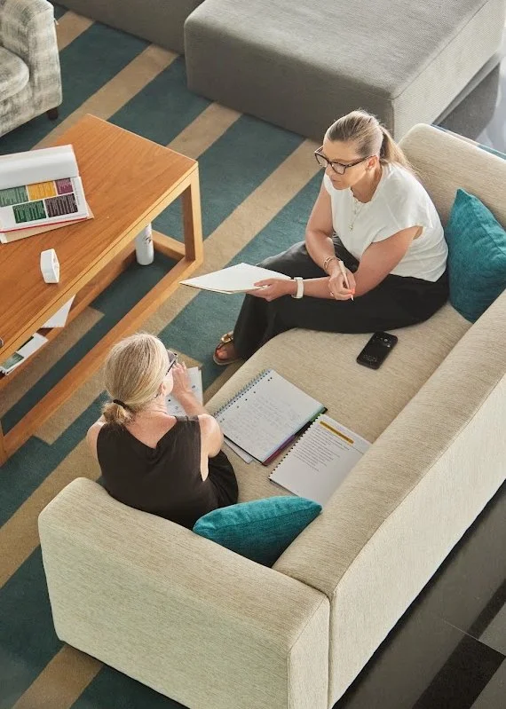 Two trainees practising ADHD-specialist coaching together on a sofa during Module 3