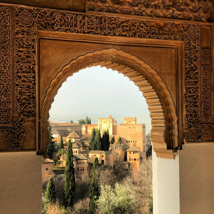 A Moorish arch framing a view over Granada