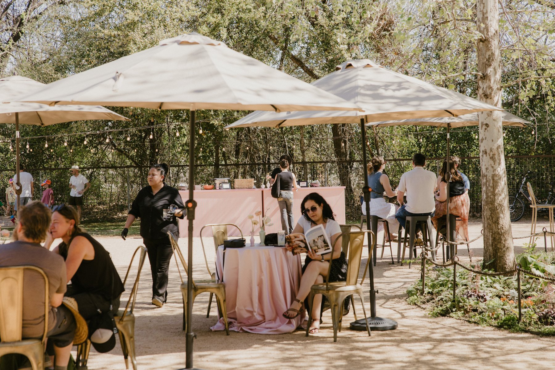 Guests gathering around cocktail tables in Springdale Station’s outdoor space.