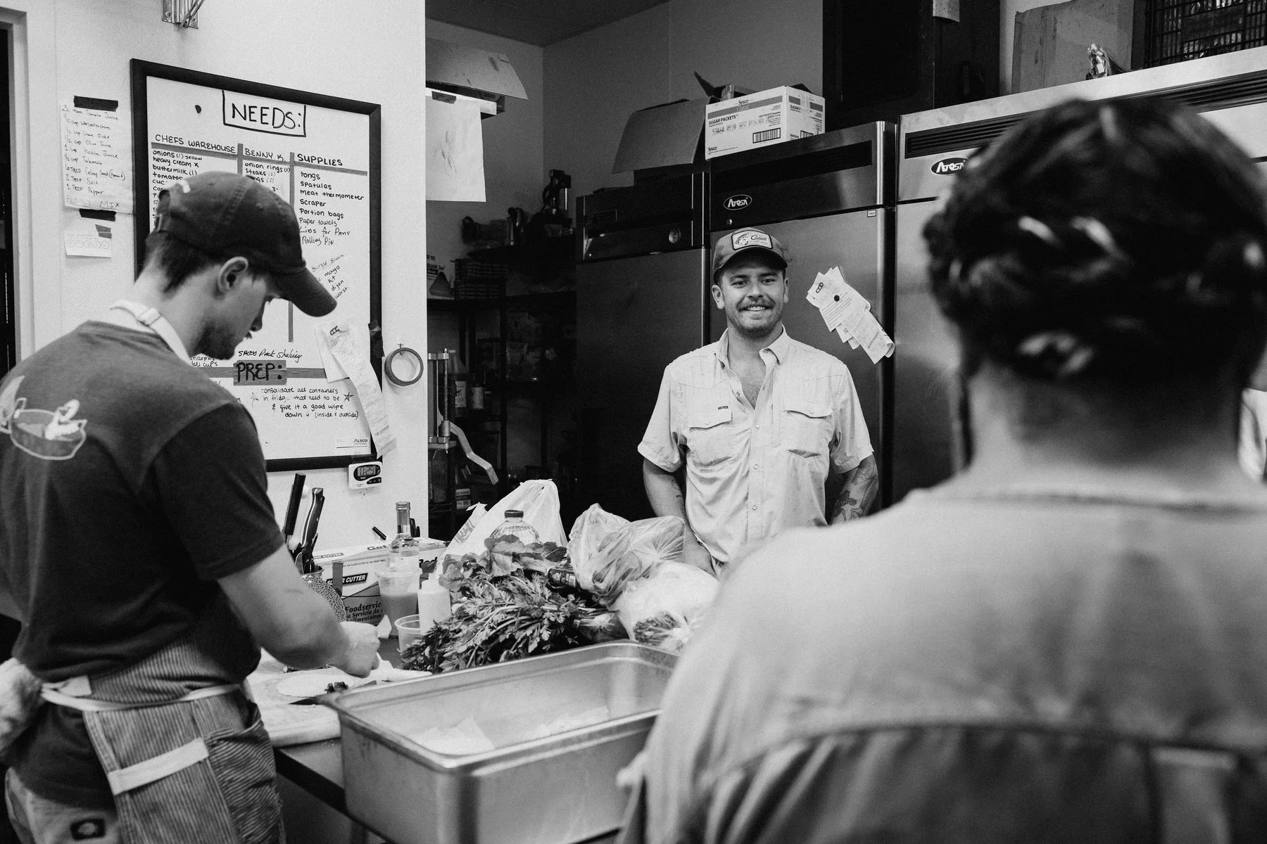 Gold kitchen crew preparing dinner at Duett’s; original black-and-white photograph.