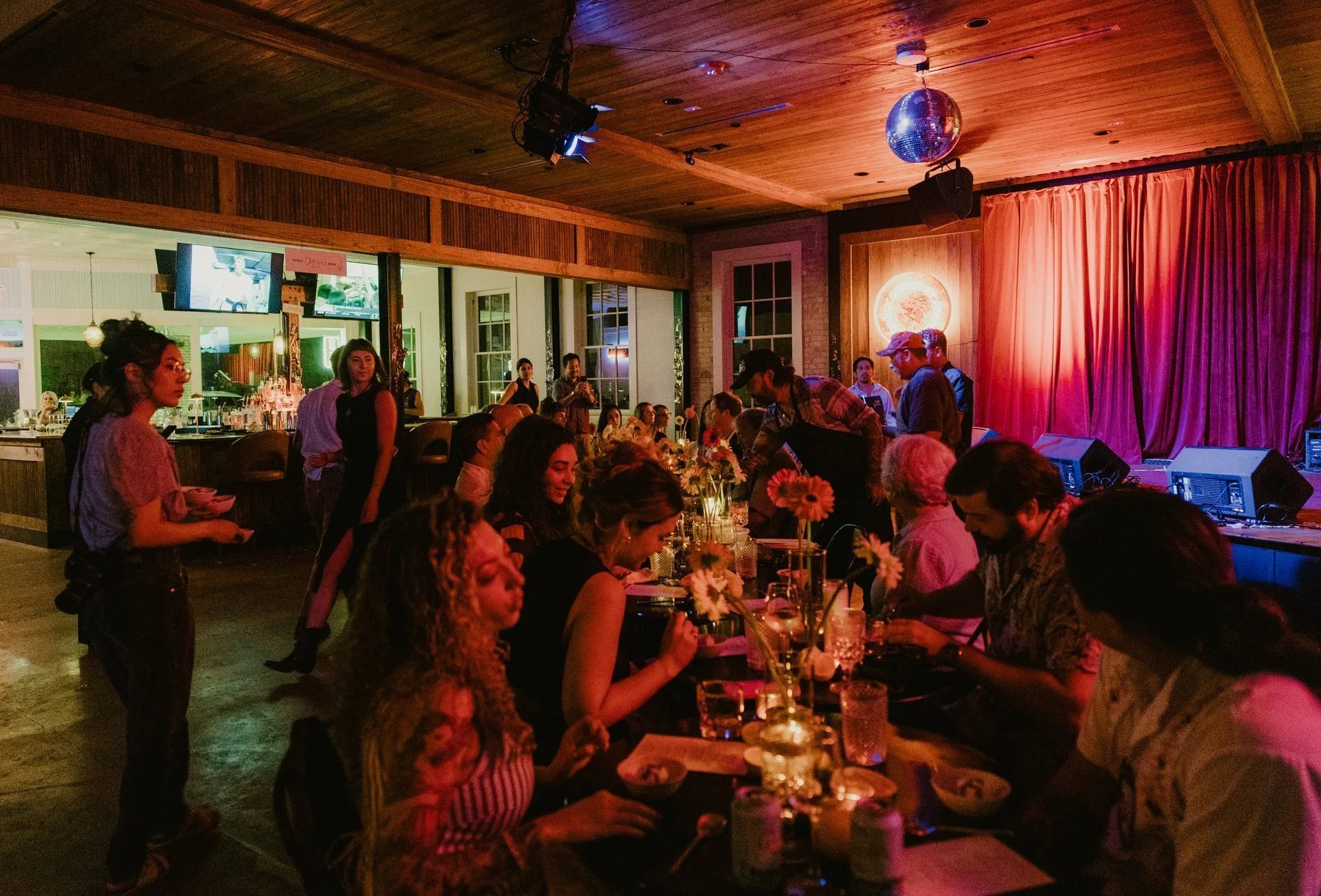 Guests gathered around a full dinner table inside Duett’s.