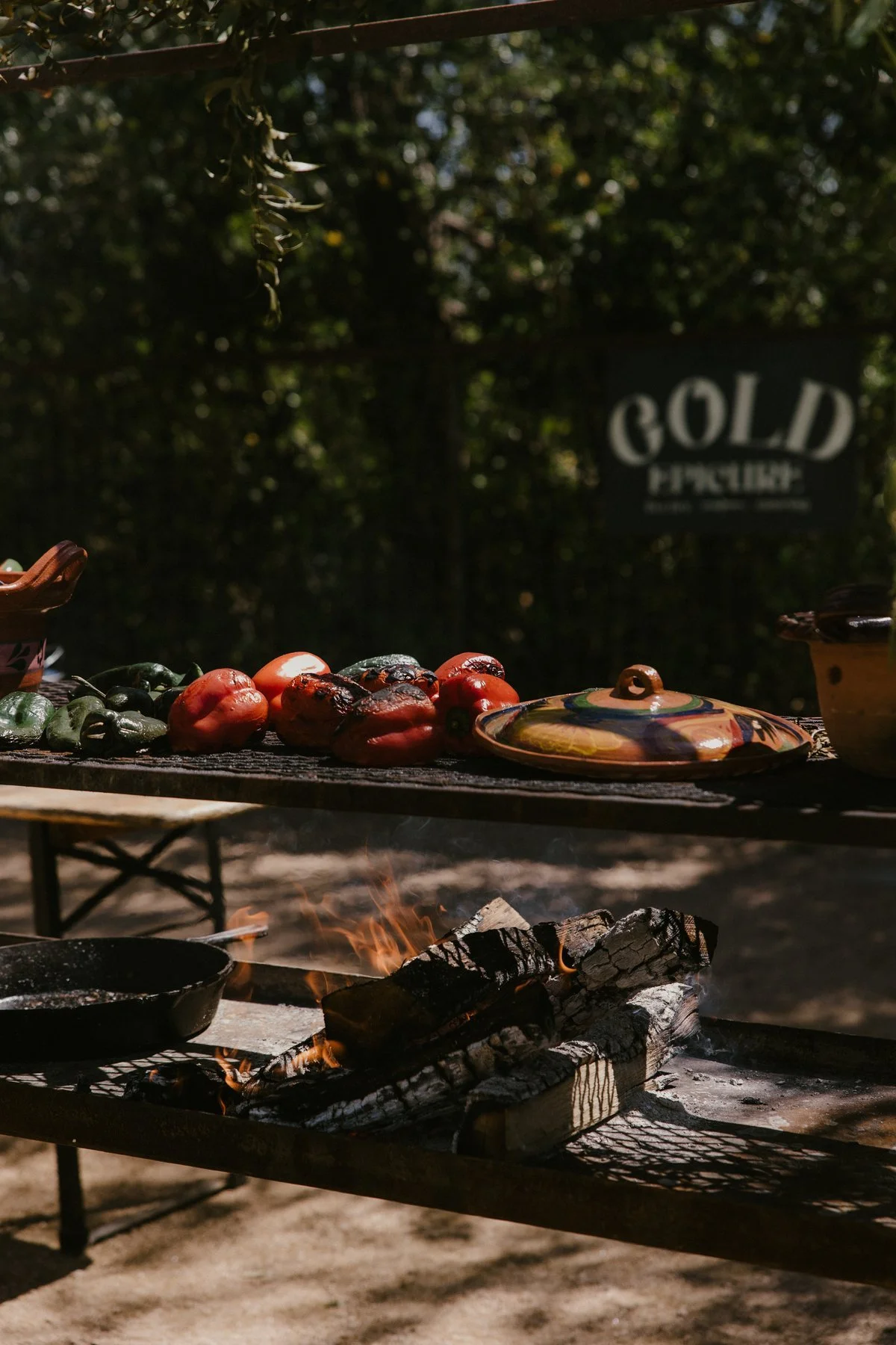 Vegetables and pans on the live-fire grill at Springdale Station.