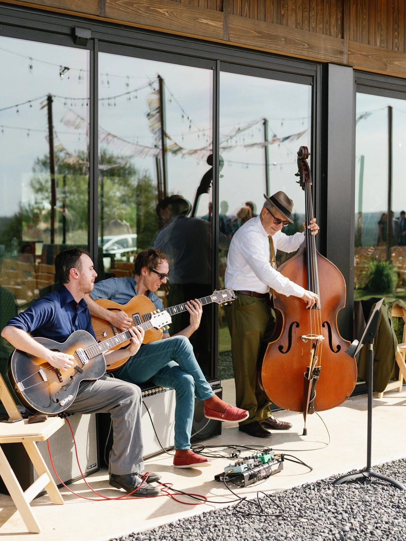 Musicians playing during the outdoor wedding gathering.