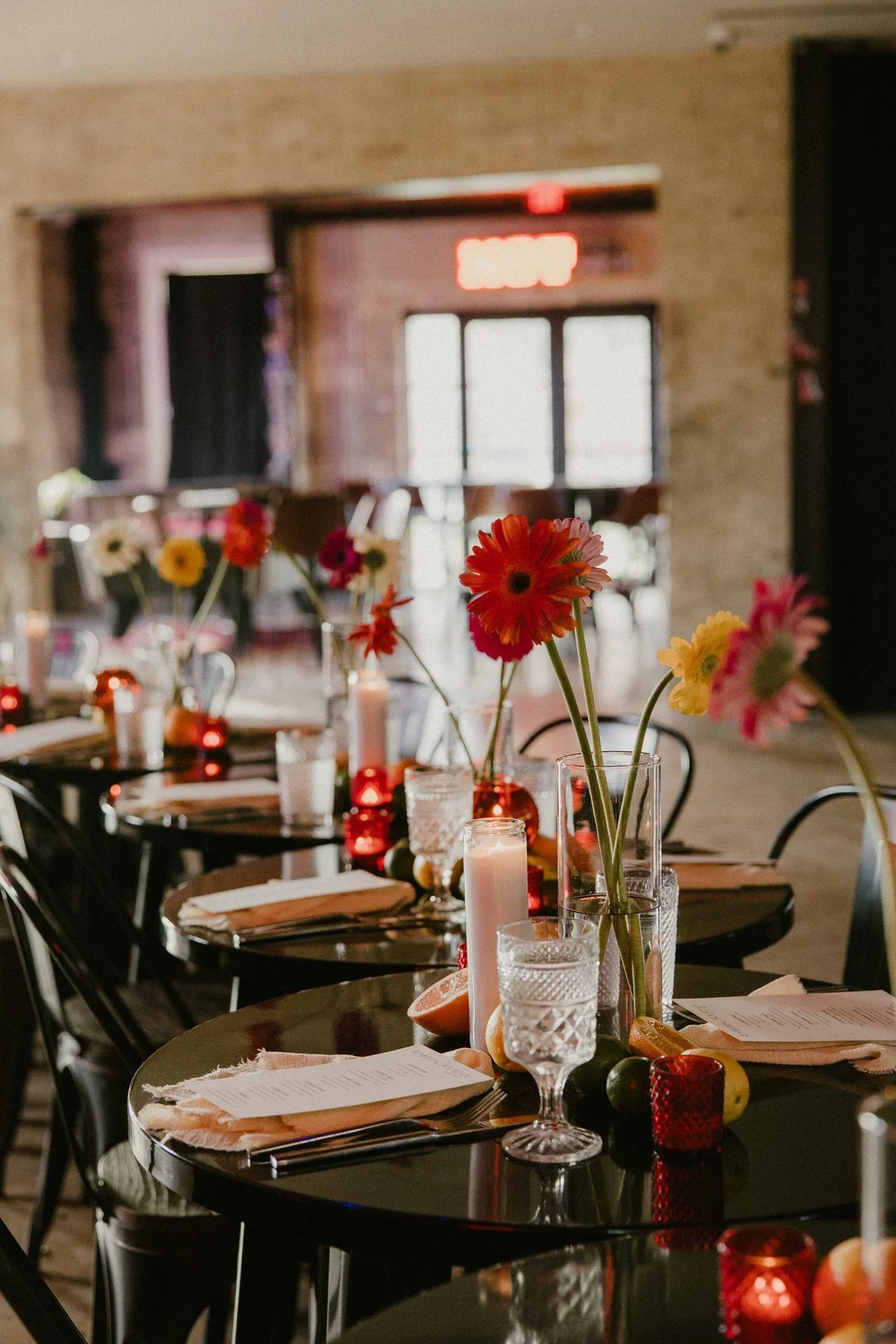 Flowers, glassware, and place settings on the long dinner table at Duett’s.