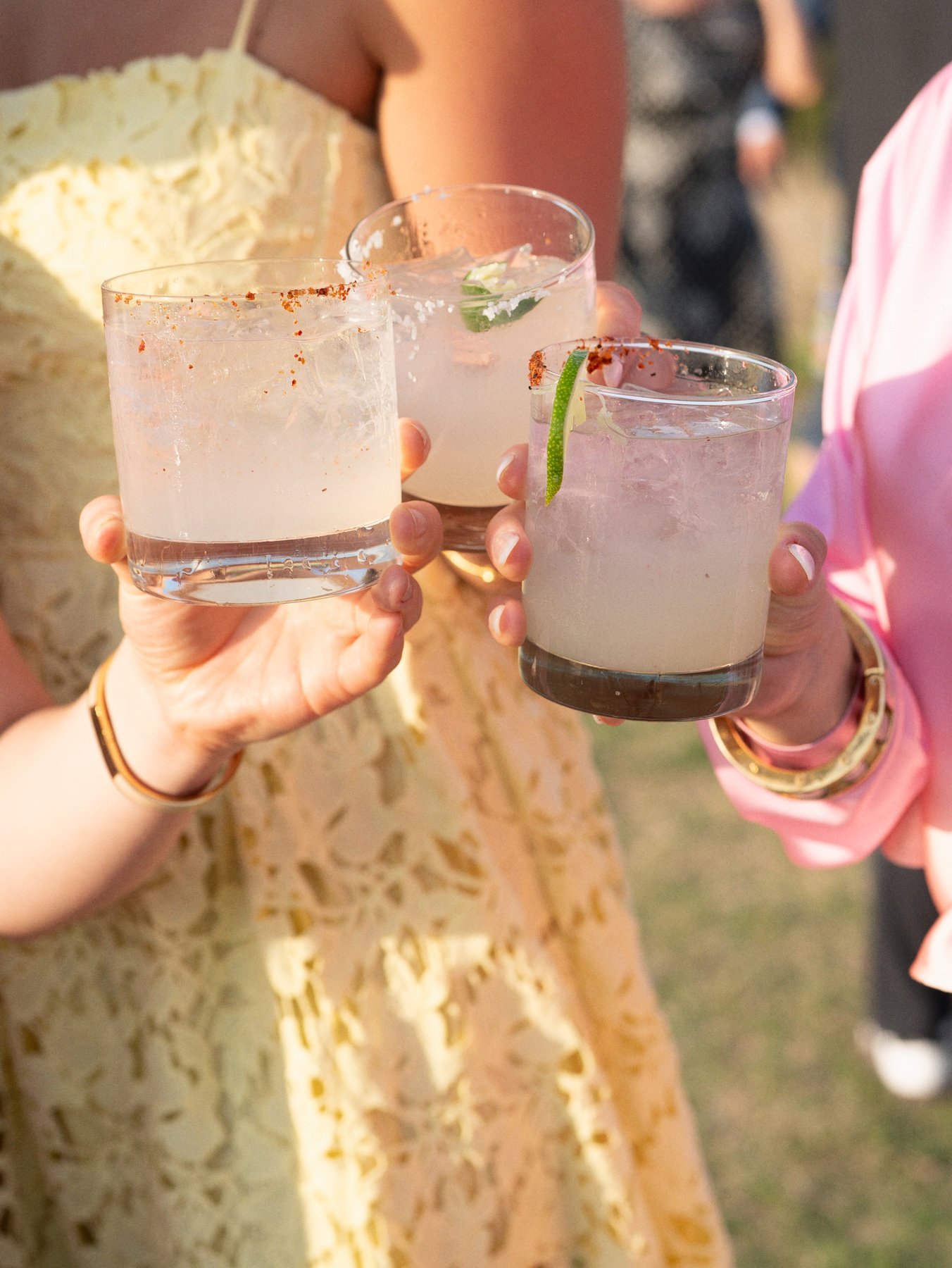 Wedding guests raising cocktails during the celebration.