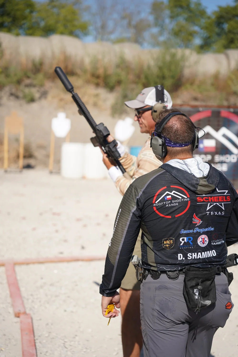 2-Gun competitor with a carbine in a Rooftop Shooting Team jersey at a PCSL match at Rooftop Shooting Range