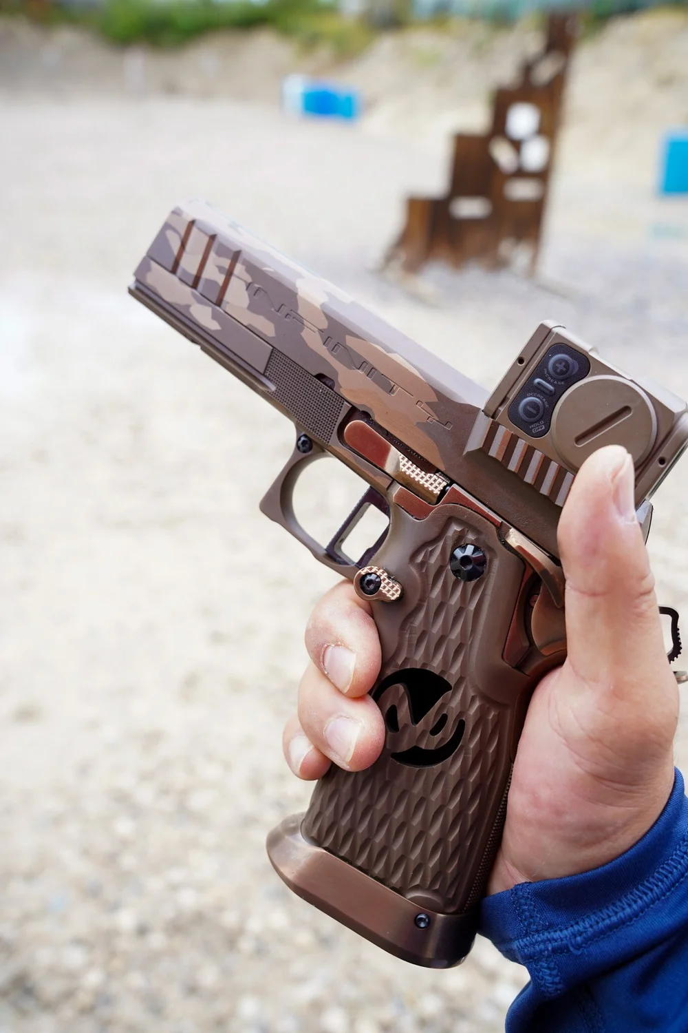 Customer holding a pistol picked up through an FFL transfer at Rooftop Shooting Range in Trenton, TX