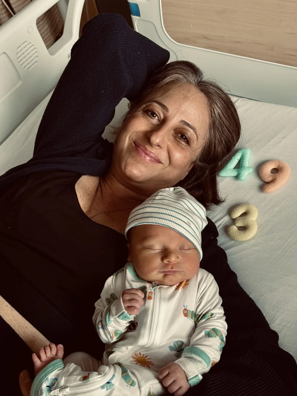 Jess in her hospital bed at 49 with her newborn son