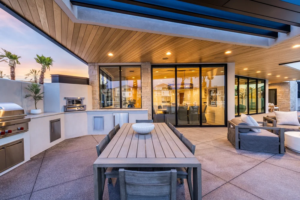 Covered outdoor dining terrace beside a swimming pool at The Oasis Utah
