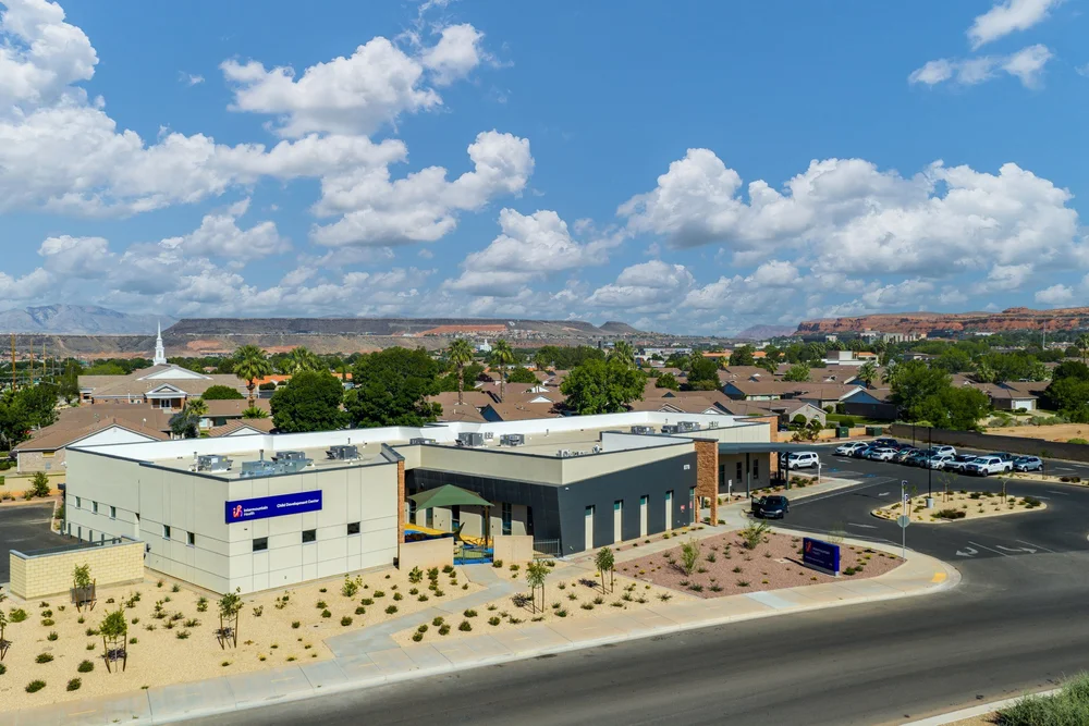 Elevated view of the building, desert landscaping and surrounding neighborhood.