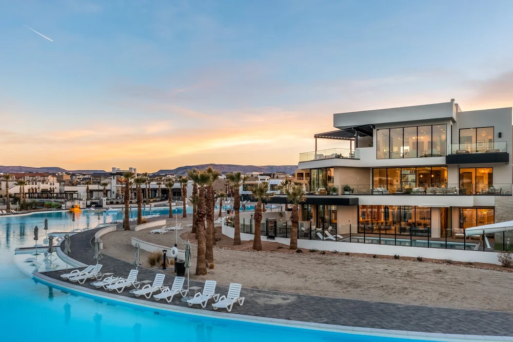 Sunset view of the lagoon, pool and modern homes at The Oasis Utah
