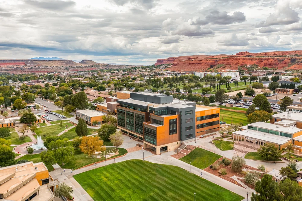 Aerial view of the Utah Tech SET building, campus lawns and surrounding red-rock landscape.