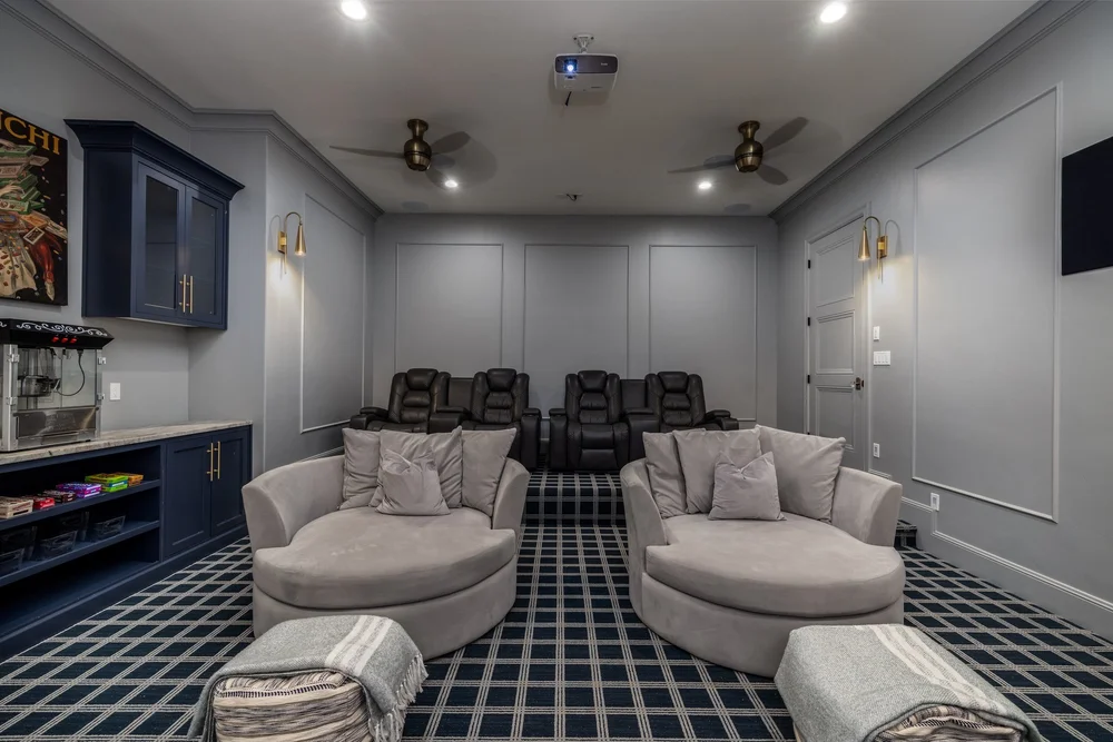 Home theater with reclining seats, lounge chairs and a ceiling-mounted projector