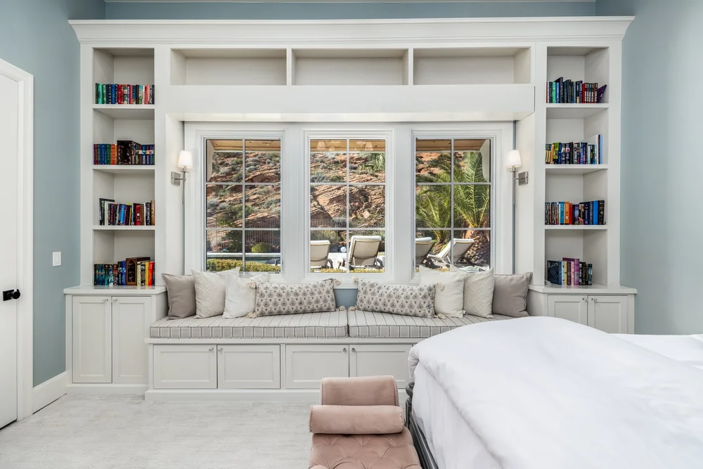 Bright bedroom with a built-in window seat and bookshelves