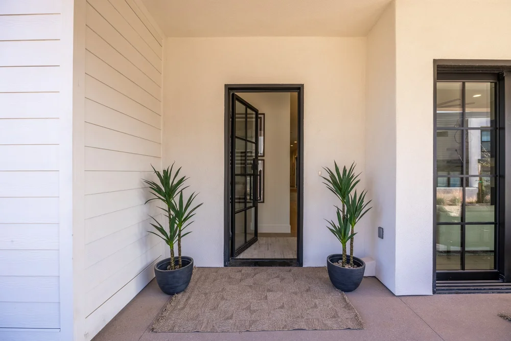Sheltered front entry with potted plants at Lula Bay