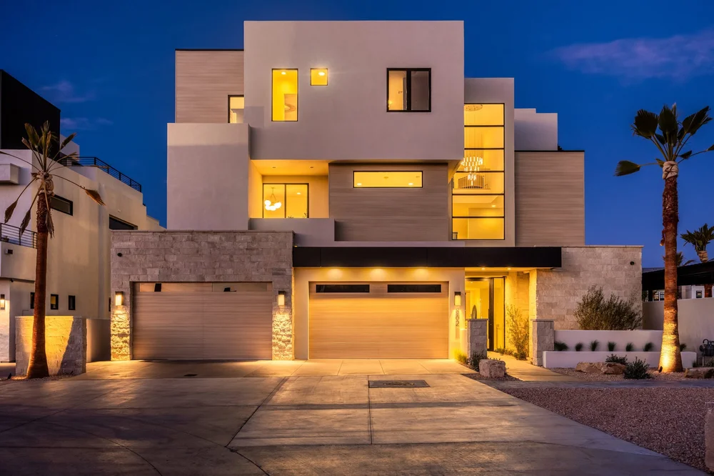 Street-facing facade with illuminated windows beneath a blue twilight sky at The Oasis Utah