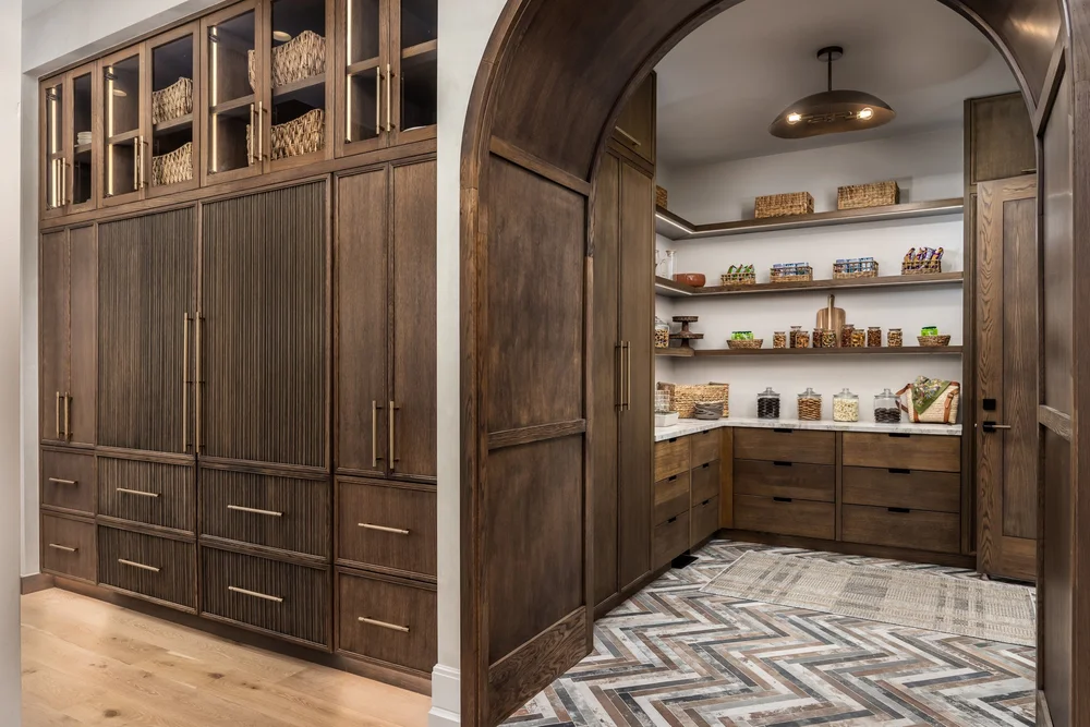 Arched wood doorway connecting the kitchen and pantry