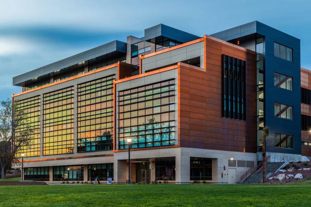 Utah Tech SET building exterior at dusk with warm light behind its gridded glass facade.