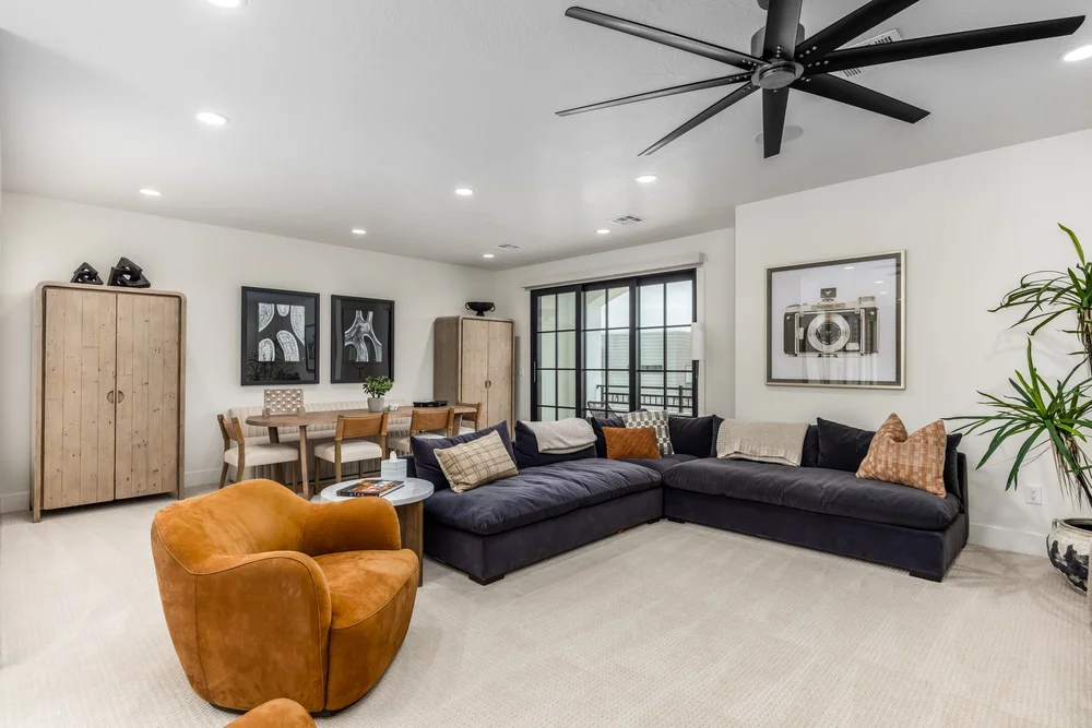 Vacation rental lounge with a sectional sofa and mustard armchair at Lula Bay