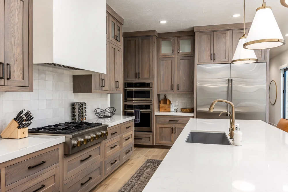 Vacation rental kitchen with wood cabinetry and a white island