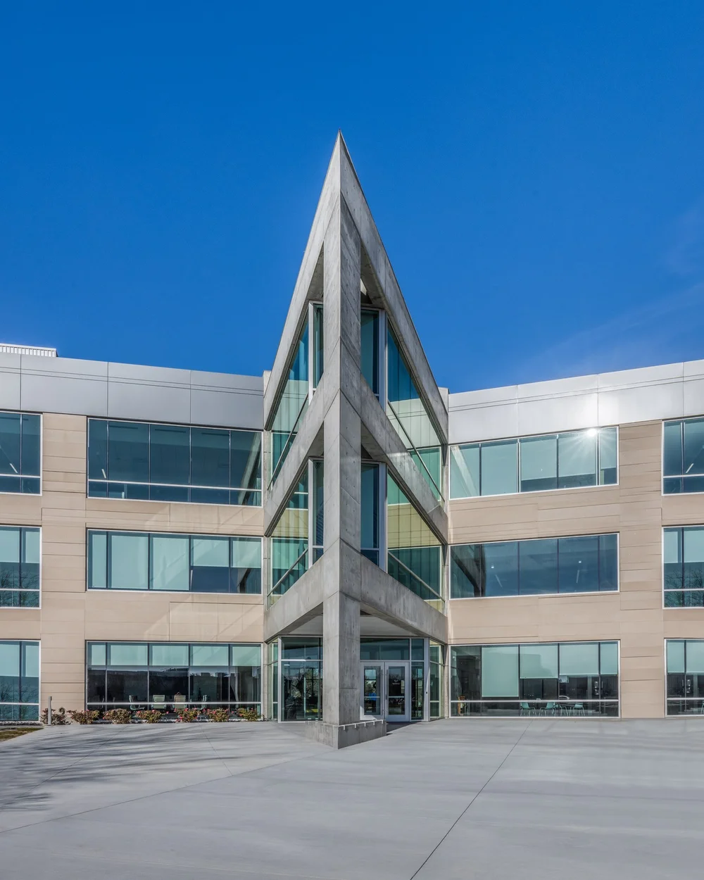 Angular glass entrance and projecting roofline at Jacobsen headquarters.