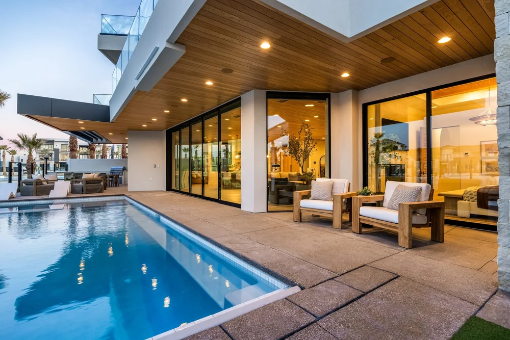 Poolside terrace and illuminated glass doors at The Oasis Utah